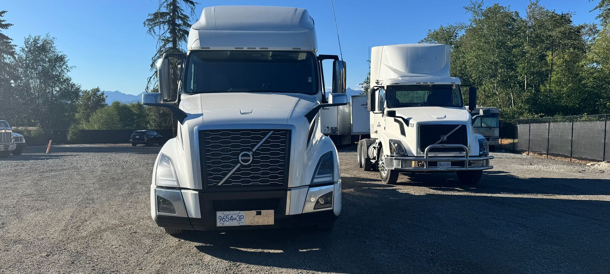 Sidhu Motors Volvo tractors at the yard against the BC mountains